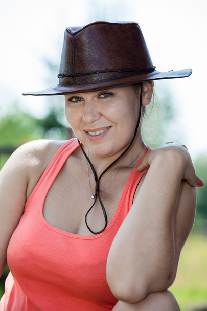 Attractive cheerful Caucasian female in cowboy hat - 写真・画像