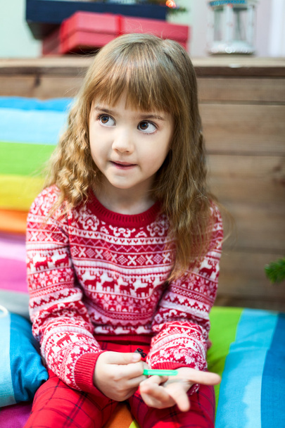 Pretty Caucasian girl portrait, red sweater in Christmas ornament and decor - Photo, Image