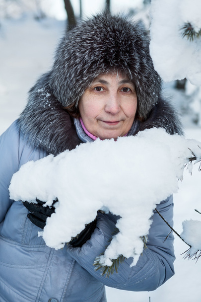 Attractive mature Caucasian woman portrait in snowy woods - Фото, изображение