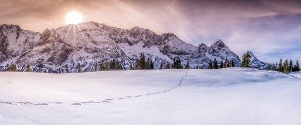 Mountain peaks with footsteps on snow - Fotó, kép