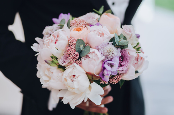groom holds a wedding bouquet - Photo, image