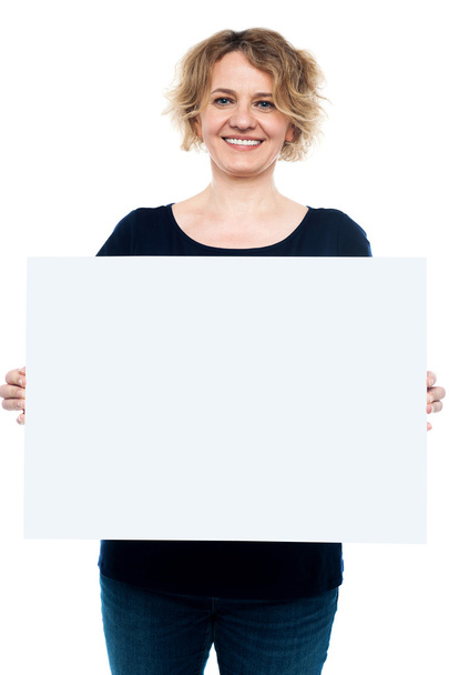 Casual lady displaying blank white billboard - Фото, изображение