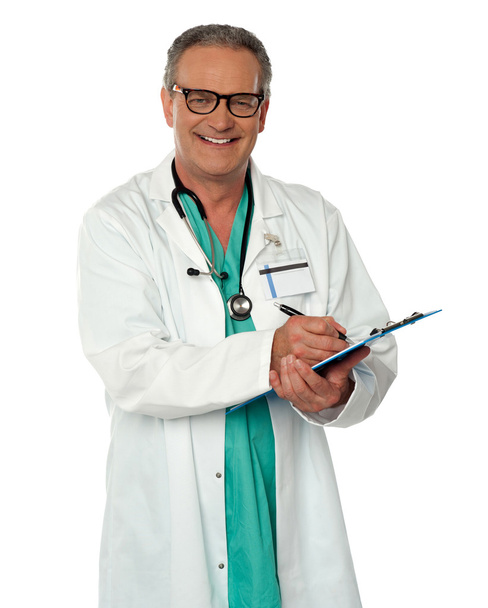 Experienced male doctor making report - Foto, Imagen