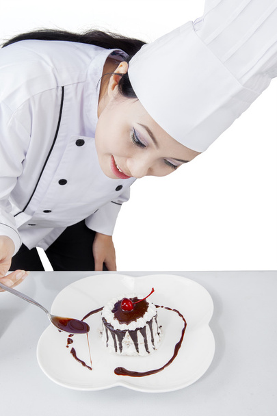Female chef decorates a cake - Photo, image