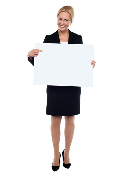 Female executive pointing towards white ad board - Foto, imagen
