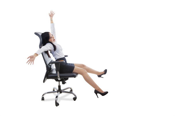 Happy female worker sits on office chair - Фото, изображение