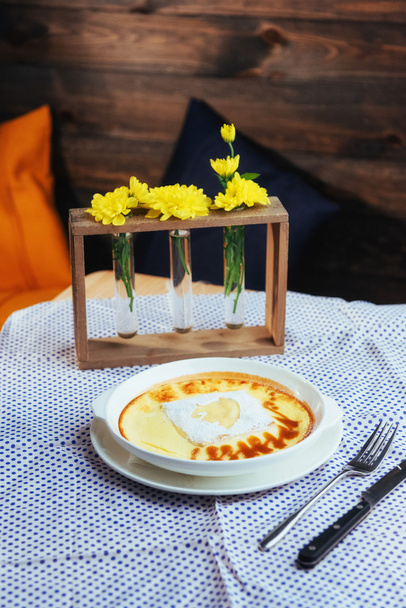 Homemade cheese casserole in plate on wooden table - Photo, image