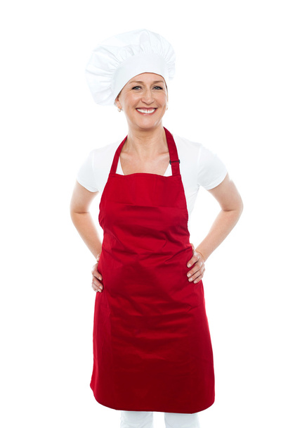 Female cook posing with hands on her waist - Фото, изображение