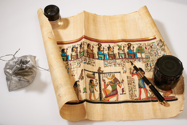 Egyptian scroll, pen, magnifier and a bag of money - Photo, Image