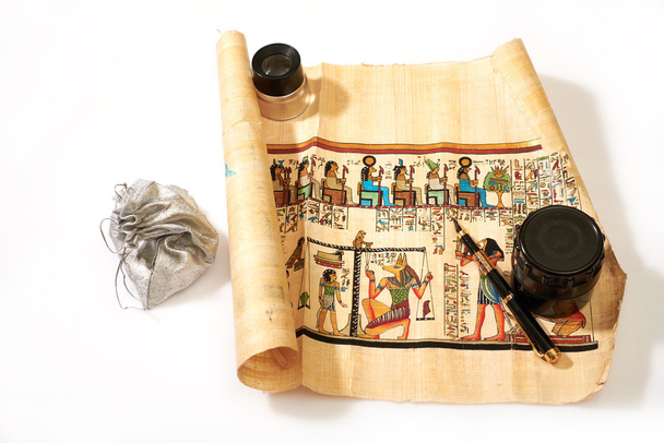 Egyptian scroll, pen, magnifier and treasures in the bag backgro - Photo, Image