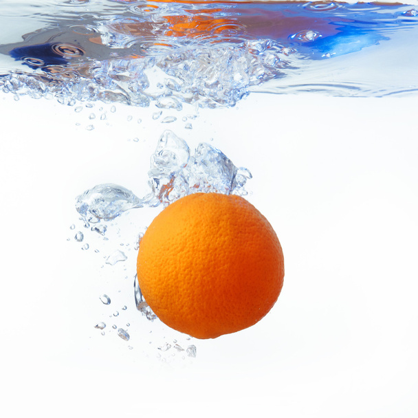 orange in spray of water. Orange with splash on white background - Valokuva, kuva