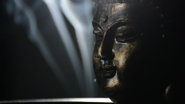 Buddha face bust, figure buddhist, rotating at black background with smoke - Video, Çekim
