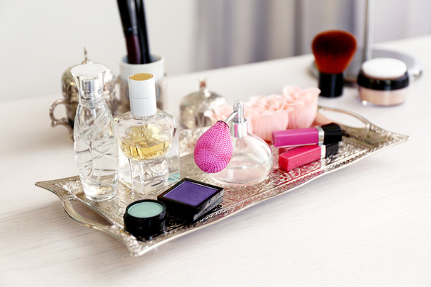 Old silver tray with cosmetics on light dressing table - Photo, image