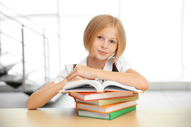 Smiling girl with many books  - Foto, afbeelding