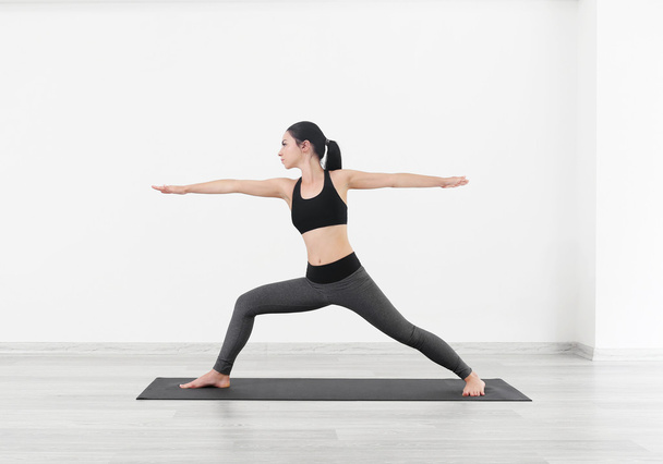 Young girl doing yoga exercises  - Fotó, kép