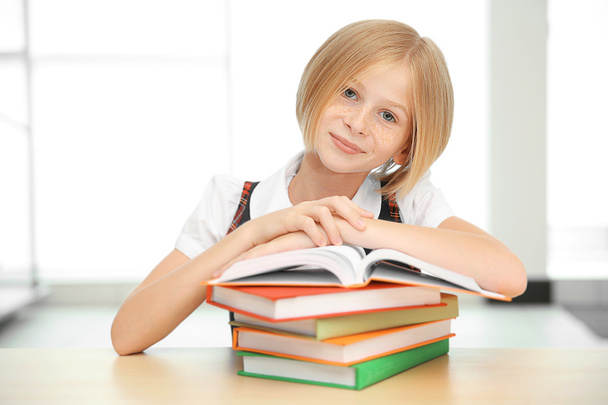 Smiling girl with many books  - Photo, image