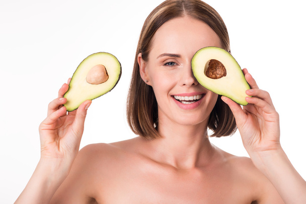 Nice young woman holding avocado - Foto, immagini