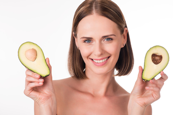 Cute young woman holding avocado - Photo, Image