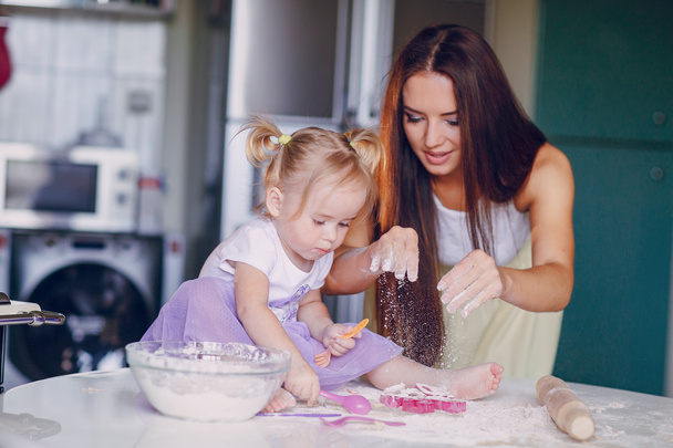 mother and daughter in the kitchen - Photo, image