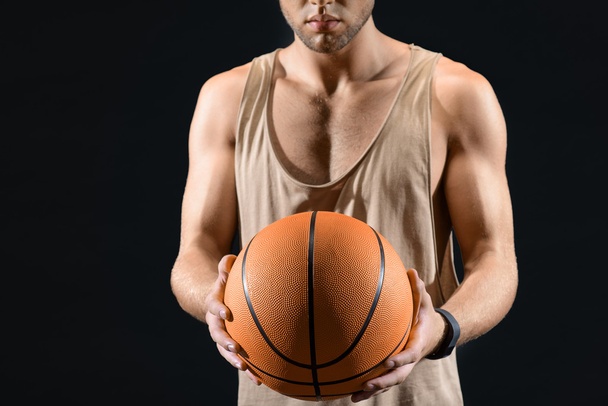 Professional basketball player holding ball - Foto, afbeelding