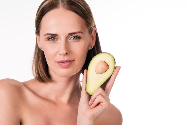 Pretty young woman with avocado - Фото, изображение