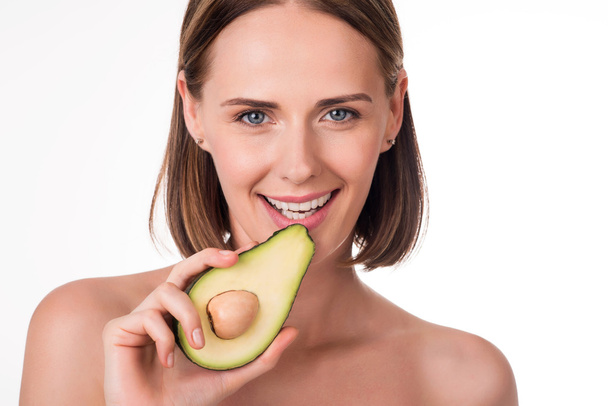 Cute young woman with avocado - Foto, imagen