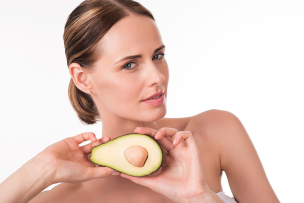 Attractive young woman holding avocado - Zdjęcie, obraz