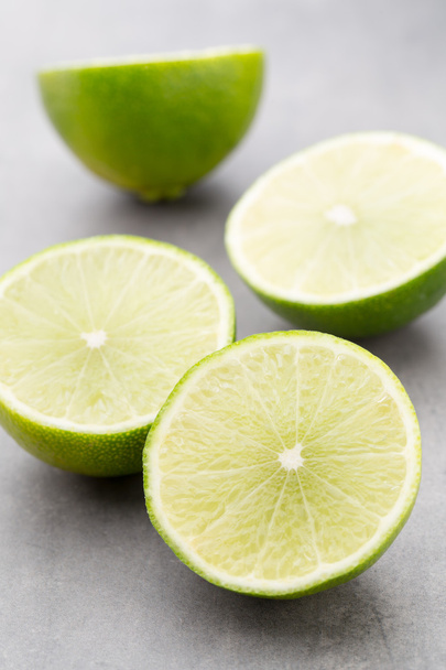 Juicy ripe lime an gray table. - Photo, Image