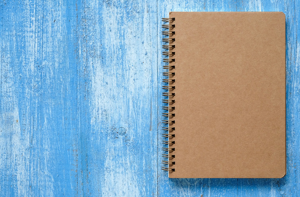 Brown notebook on blue wooden floor. - Fotografie, Obrázek