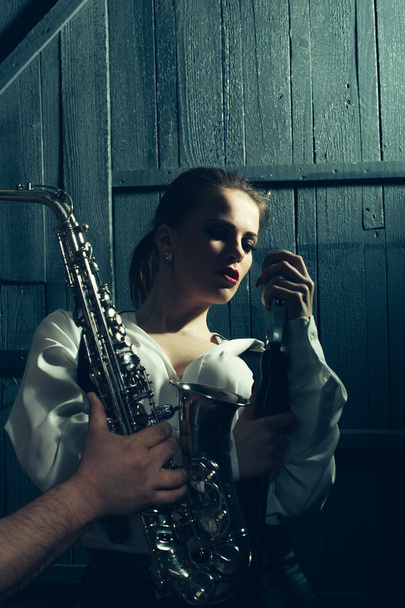 woman with microphone and man with sax - Foto, immagini