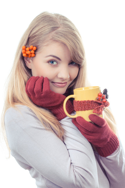 Vintage photo, Happy smiling girl in woolen gloves holding cup of tea wrapped scarf - 写真・画像