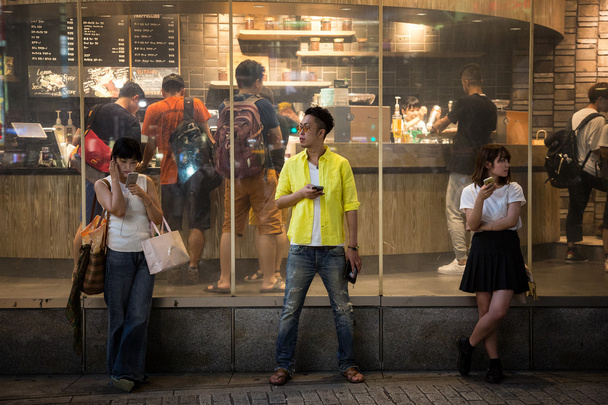 people with their mobile phones in Tokyo - Photo, Image