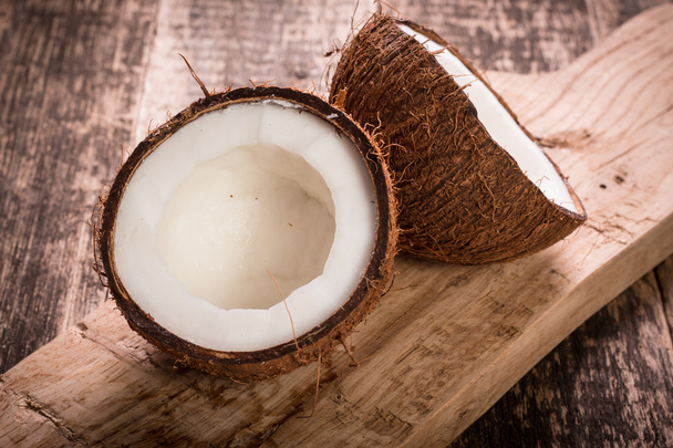 Coconut on wooden table. - 写真・画像