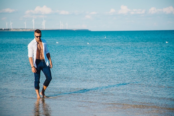 férfi séta a strandon - Fotó, kép