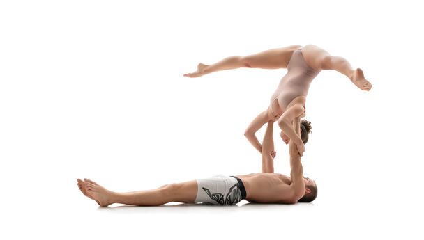 Acrobatic duo trains in studio. Isolated on white - Valokuva, kuva