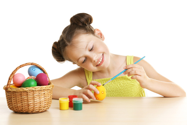 Cute girl painting Easter eggs  - Foto, afbeelding