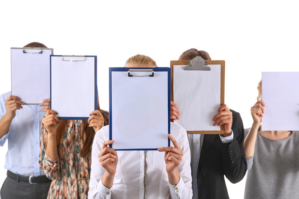 Team of businesspeople holding a folders near face isolated on white background - Φωτογραφία, εικόνα