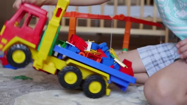 the child plays with the toys in the playroom - Filmati, video