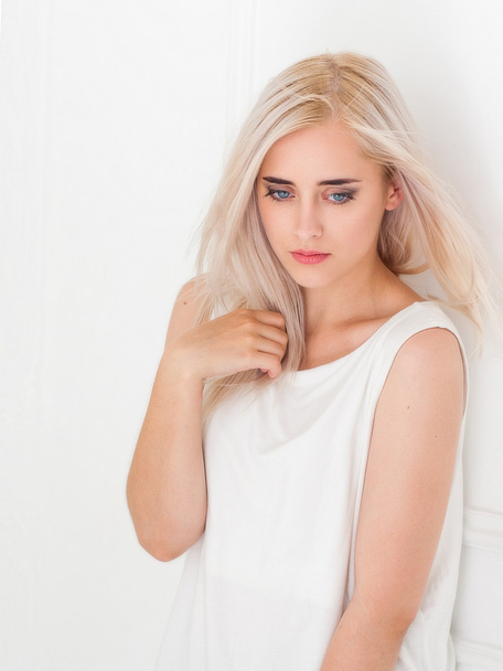 Beautiful blue-eyed blonde with pensive look - Фото, зображення