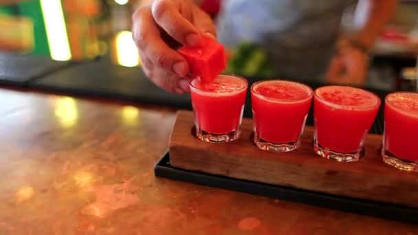 The bartender is decorated cocktail with watermelon - Кадри, відео