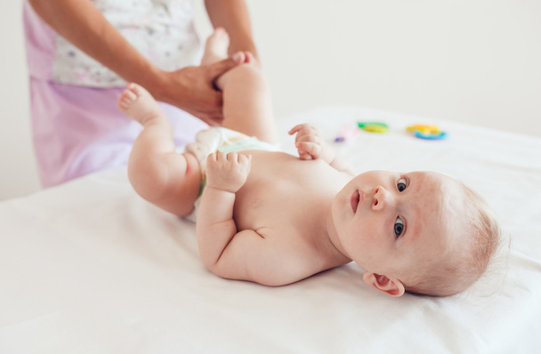 Woman doing exercises and massage the baby - Photo, image