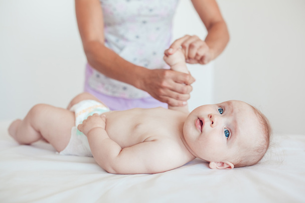 Woman doing exercises and massage the baby - Photo, Image