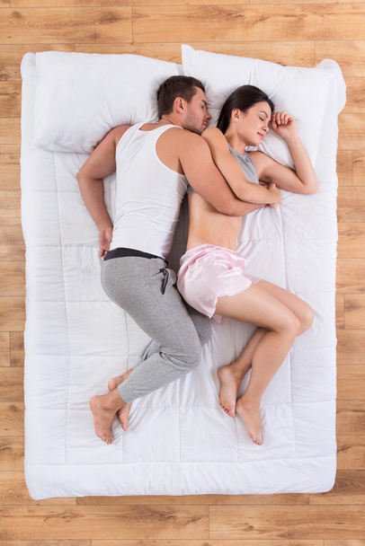 Lovely couple sleeping on bed - Фото, изображение