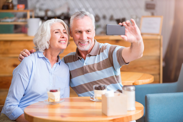 Positive senior couple resting in the cafe - Photo, image