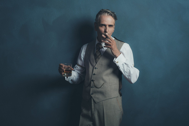 Retro businessman 1920s style smoking cigar - Foto, immagini