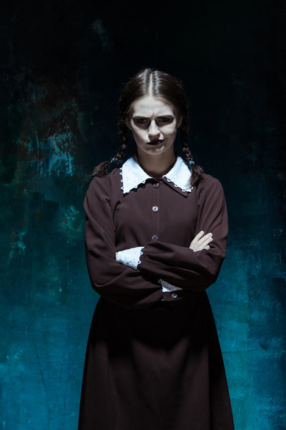 Portrait of a young girl in school uniform as killer woman - Valokuva, kuva