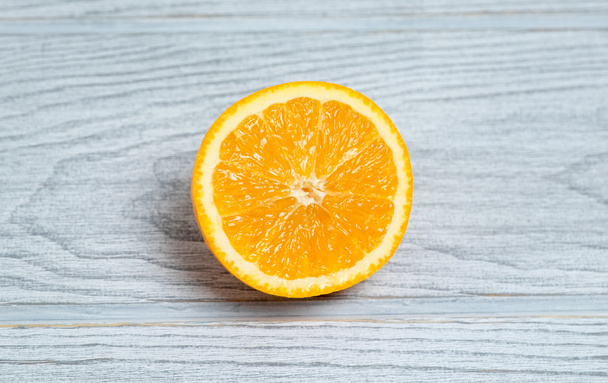 Orange sliced on wooden background - Photo, Image