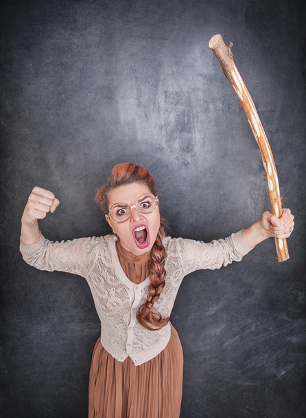 Angry screaming teacher with wooden stick  - Photo, Image