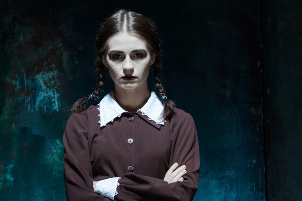 Portrait of a young girl in school uniform as killer woman - Fotó, kép
