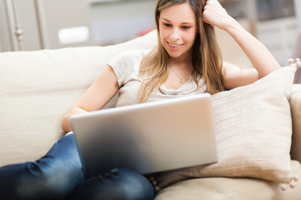 Nő használ egy laptop a kanapén - Fotó, kép